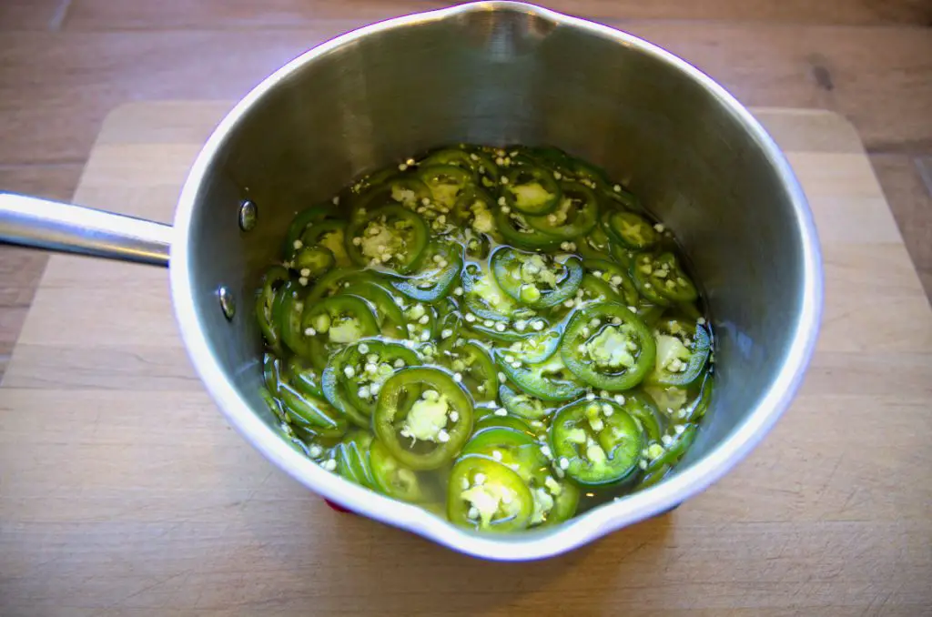 allowing jalapeños to pickle in hot brine